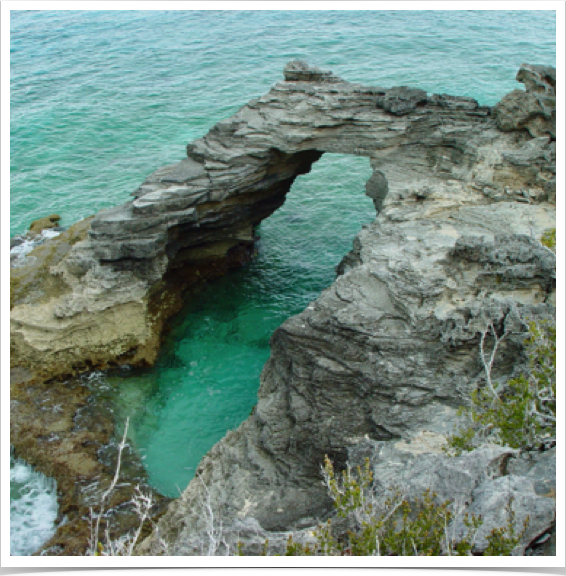 Natural arch in Rum Cay - opening formed underneath natural rock due to erosion from the sea or weathering (subaerial processes).