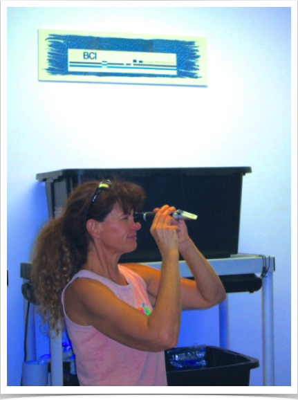 Dr. Alshuth analyzing and recording oceanographic parameters of coral sunscreen study.
