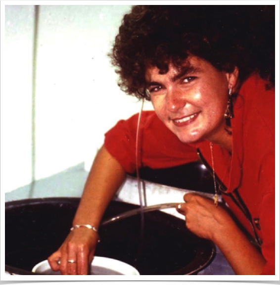 Tank maintenance at fish hatching facility - observing larval growth.